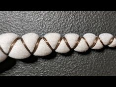 a close up of a white rope on a black surface