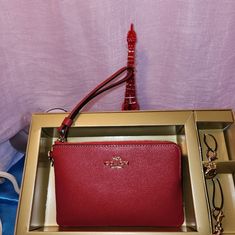 Coach Red Wrislet With Two Charms. New In Gift Box. Retail Value $ 128. Coach Pouch Clutch Gift, Coach Clutch Gift Pouch, Coach Pouch Clutch As Gift, Elegant Red Travel Pouch, Red Coach Clutch For Gift, Red Coach Clutch As A Gift, Chic Red Coach Wallet, Red Rectangular Coach Wallet, Coach Red Rectangular Wallet