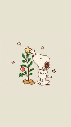 a snoopy christmas tree with a star on it and a dog standing next to it