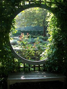 a wooden bench sitting in the middle of a garden