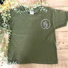 This Cactus Green Shirt Is Just Perfect For Any Occasion, This Shirt Is A Olive Green Color With White Cactus Outline, The Brand Is Gildan, The Shirt Material Is 100% Preshrunk Cotton, Size 6t, The Shirt Is 15”X 18” Made In Honduras, Cactus Outline, White Cactus, Superman T Shirt, Moschino Kids, Tie Dye Shirts, Yellow Ties, Beach T Shirts, Blue Camo, Beach Kids