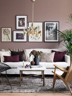 a living room filled with lots of furniture and pictures on the wall above it's coffee table