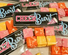 candy wrapped in cellophane and decorated with name tags for cheer bar party favors