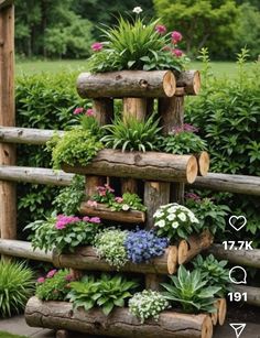 a wooden planter filled with lots of different types of flowers and plants in it