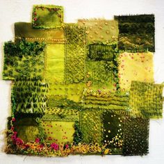 a piece of art made out of green and yellow fabric