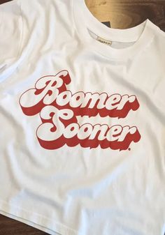 Alternative image 1 for Oklahoma Sooners Womens White Short n Sweet Crop Short Sleeve T-Shirt. White Fan Apparel Tops With Lettering, White Tops With Lettering For Fan Merchandise, Cotton Band Merch Tops With Lettering, White Fan Merchandise Tops With Lettering, Retro Relaxed Fit Tops With Lettering, White Fan Apparel T-shirt With Lettering, White Lettering T-shirt For Spring, Retro White Tops With Lettering, White Slogan Tops For Fan Apparel