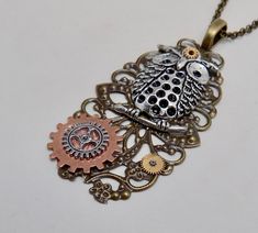 "Awesome steampunk pendant of owl charm and gears mounted on brass victorian filigree. The size is 2\" by 1 1/4\" and it has 24\" antique brass chain." Steampunk Bronze Brass Jewelry, Steampunk Brass Jewelry In Bronze, Steampunk Metal Jewelry With Antique Finish, Steampunk Jewelry With Antique Metal Finish, Handmade Steampunk Brass Necklaces, Handmade Steampunk Brass Necklace, Steampunk Bronze Nickel-free Necklace, Bronze Steampunk Metal Necklace, Steampunk Metal Necklaces With Antique Finish