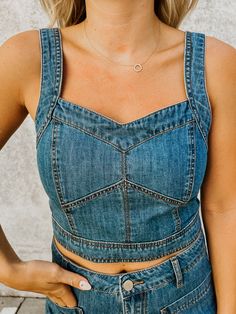 Fits TTS- the model is wearing a medium. The Dawson Denim Bustier Top is a medium denim wash bustier style top with back zipper closure. 90% Cotton 10% Polyester Fitted Washed Cropped Tops, Fitted Washed Denim Blue Top, Fitted Denim Tops In Dark Wash, Dark Wash Fitted Cropped Denim Top, Fitted Cropped Dark Wash Denim Top, Washed Denim Cropped Tops, Fitted Light Wash Denim Top, Fitted Denim Vest In Medium Wash, Cropped Washed Denim Tops