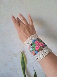 Linen detachable cuff bracelet with Embroidery are an extraordinary accessory that adds elegance to your casual clothes and turn them into haute looks and burst into your linen paradise. This beautiful unique Design linen fabric bracelet is made with embroidered  pink flowers with finishing lace and beads . Button closure. This cuff can be worn like real bracelet. The whole composition has a Boho Chic Style- elegant air and can be the piece of resistance for any outfit. You can wear them like on Bohemian Cuff Bracelets For Spring, Spring Bohemian Cuff Bracelet As Gift, Spring Bohemian Cuff Bracelet For Gift, Elegant Adjustable Decorative Bracelets, Bohemian Embroidered Cuff Bracelet For Gift, Bohemian Embroidered Cuff Bracelet As Gift, Bohemian Cuff Bracelet For Spring, Spring Bohemian Cuff Bracelet, Elegant Embroidered Bracelets As Gift