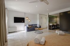 a living room filled with furniture and a flat screen tv on top of a wall