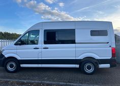 a white van parked in front of a fence