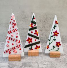 three ceramic christmas trees with candy canes on them