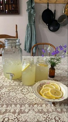 two mason jars filled with lemonade sit on a table