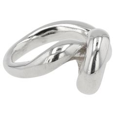 The Sterling Silver Mangala Curl Ring by Ariana Boussard-Reifel is a striking piece that elegantly wraps around the finger with fluid, curling lines. This ring captures modern sophistication and timeless beauty, making it a versatile addition to any jewelry collection. A scribbling spiral that creates an artistic gesture across the finger. The coil is thick and substantial, giving the wearer a soothing feel. It is available in size 7 and can be sized. Ariana Boussard-Reifel is a renowned jewelry designer who is celebrated for her bold, sculptural pieces inspired by global artifacts and ancient cultures. Her work merges traditional craftsmanship with contemporary design, resulting in unique, wearable art. Boussard-Reifel’s creations have garnered acclaim for their innovative forms and metic Modern Bangle, Modern Hoop Earrings, Twisted Bangle, Snake Ring Silver, Triangle Ring, Snake Design, Modern Ring, Sterling Silver Hoop Earrings, Oxidized Sterling Silver