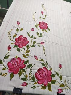 the table cloth has pink flowers on it