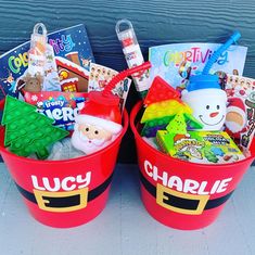 two red buckets filled with toys and books