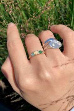 This Earthy Opal Engagement Ring is the perfect way to wrap your hands in love. These Rings are made with genuine Raw free-formed Opal, emerald and aquamarine in their natural state. It's crafted in a Solid Sterling silver/14k/18k Gold Specification: Gemstone: Raw Opal, emerald, aquamarine Center Opal Size: 4.5mm*5.5mm Materials: Solid Sterling Silver, Solid 14k/18k Gold Style: Engagement Ring *Gems: The raw gems natural hues vary, adding an organic touch to your ensemble. I'll try to select the Heirloom Emerald Gemstone Ring For Promise, Heirloom Emerald Ring For Promise May Birthstone, Fine Jewelry Emerald Promise Ring With Birthstone, Heirloom Emerald Ring With Accent Stones As Gift, Fine Jewelry Emerald Ring For Promise With Birthstone, Fine Jewelry Emerald Birthstone Ring For Promise, Heirloom Emerald Ring With Accent Stones For Gift, Fine Jewelry Emerald Ring For Promise, Fine Jewelry Rings With Ethiopian Opal Birthstone