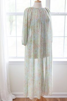 1980s vintage pastel floral nightgown made of the softest lightweight nylon I've ever felt! Seriously, this gown feels like a dream on! There are pretty gathers along the neckline and the muted daisy pattern throughout is perfection. This gown is in great vintage condition and would fit an array of sizes from Small to possibly large depending on desired fit - see measurements below while dress is flat on table: Chest: 38 in (measurement already doubled) hips: free Length: 52 in Brand: Mistee Fab Long Sleeve Floral Print Nightgown For Spring, Long Floral Print Sleepwear For Spring, Spring Sheer Nightgown For Sleep, Spring Bohemian Nightgown For Sleep, Sheer Nightgown For Spring Sleepover, Bohemian Sleep Dresses For Spring, Spring Beach Sheer Nightgown, Sheer Nightgown For Beach Spring Season, Sheer Nightgown For Beach In Spring