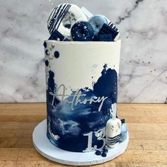 there is a blue and white cake on the table