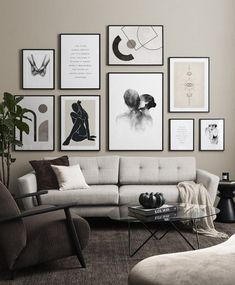 a living room filled with furniture and framed pictures on the wall above it's coffee table