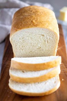 a loaf of bread sitting on top of a wooden cutting board