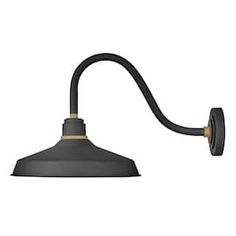 an industrial style wall light with a gray shade on the side and gold trimmings