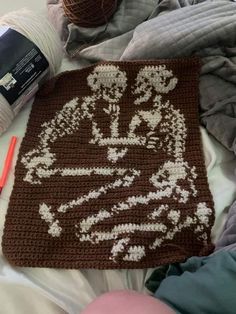 a crocheted blanket with white flowers on it