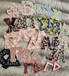 the letters are made out of fabric and have different designs on each letter, including one that says boy or girl