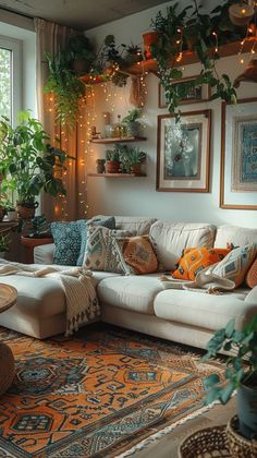 a living room filled with lots of furniture and plants on the wall above it's windows