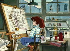 a woman sitting at a desk in front of a easel with a drawing on it