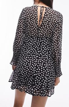 Bold polka dots cover this charming chiffon minidress framed by long sleeves with cute smocked cuffs and made twirly with a godet-flared skirt. Back keyhole with tie closure V-neck Long sleeves with smocked cuffs Lined, except sleeves and back 100% polyester Machine wash, line dry Imported