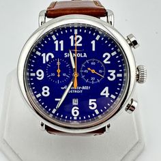 This  Shinola Chronograph watch is a beautiful timepiece that is built to last, and built right here in America.  Features: - Stainless steel 47mm case - Aniline latigo brown leather strap with minimal usage - Tang closure - Blue dial - Black and orange hands - Saphire Crystal - Luminescent hands - A lightning bolt is stamped on the back of each watch, representing Shinola's commitment to quality - Argonite 5021 quartz chronograph movement - Water resistant at 50 meters - Built in the US with Sw Shinola Womens Watch, Blue Round Watch With Tachymeter, Vintage Blue Chronograph Watch Accessories, Blue Leather Analog Watch, Vintage Blue Chronometer Watch, Shinola Watch, Black And Orange, Brown Leather Strap, Lightning Bolt