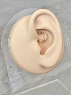 a close up of a fake ear with a ring on it