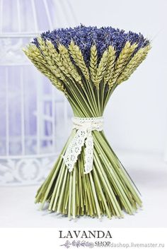 a bunch of lavenders tied to a white ribbon with a birdcage in the background