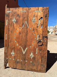 an old wooden door with decorative designs on it