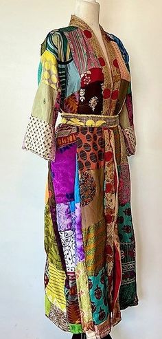 This stand-out kimono is full kaleidoscope of bright colors like a blooming spring garden. Constructed with high quality, ultra luxe sari silk, handmade. Designed as a traditional long kimono with an extra wide front band and self tie belt. Special detailing is noticable throughout the garment, double width hem panel, etc. Feels wonderful against your skin. Worn open, breezy flowing statement. The bright color pallet works well with most skin tones. True statement, one-of-a-kind designer piece. Bollywood Style Long Sleeve Multicolor Kaftan, Bollywood Style Multicolor Long Sleeve Kaftan, Handmade Multicolor Spring Kimono, Multicolor Hippie Kimono With Kimono Sleeves, Hippie Multicolor Kimono With Kimono Sleeves, Multicolor Handmade Kimono With Kimono Sleeves, Handmade Multicolor Kimono With Kimono Sleeves, Bohemian Multicolor Silk Kimono, Bollywood Style Multicolor Kaftan For Spring