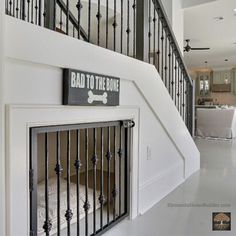 there is a dog gate on the wall next to the stairs in this house that has been built into the floor