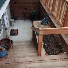 an outdoor patio with wooden steps and planters