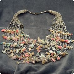 Shell bib necklace contains a fabulous 20 strands of glistening silvery seed beads and pastel shell pieces create a big, yet light and summeryand beautifully bohemian look.  Hook closure. Unmarked,   Very good condition - one small metal bead by the connector bar is missing - doesn't cause any issues and not easily noticeable. Wearable length:  17 inches and bib is about 5-6 inches at widest part.Find lots more vintage jewelry at Purple Daisy Jewelry:http://www.etsy.com/shop/purpledaisyjewelryTh Bohemian Silver Shell Jewelry, Silver Bohemian Shell Jewelry, Silver Shell-shaped Bohemian Jewelry, Bohemian Beaded Pastel Jewelry, Bohemian Strand Beaded Necklaces For Jewelry Making, Handmade Silver Bohemian Beaded Necklaces, Handmade Silver Beaded Bohemian Necklace, Bohemian Silver Jewelry With Mother Of Pearl, Bohemian Silver Beads Jewelry For Beach