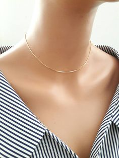 "Handmade by Eriko Design Studio in Brooklyn, NY Delicate gold snake chain choker necklace- basic yet stylish: it can be layered with other chokers or necklaces. -------------------- DETAILS ・1 mm 24K gold plated snake chain ------------------- SIZE ・Available in 4 sizes 12\"- 14\" ( 12 inches + adjustable 2 inch extender) 14\" -16 \"( 14 inches + adjustable 2 inch extender) 16\"- 18\"( 16 inches + adjustable 2 inch extender) 18\"-20\"(18 inches + adjustable 2 inch extender) ・It closes with lobs Everyday Necklace Gold, Unique Choker Necklaces, Choker Necklace Gold, Dainty Chain Necklace, Gold Snake Chain, Gold Chain Choker, Chevron Necklace, Snake Chain Necklace, Necklace Simple