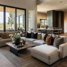 a living room filled with furniture and lots of windows