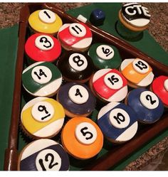 cupcakes with numbers and pool balls in a tray