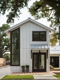 a white house with brown trim and windows