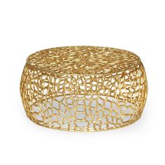 a gold coffee table with an intricate design on the top and bottom, in front of a white background