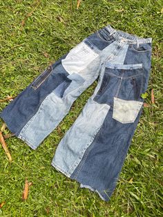 two pairs of jeans laying on the grass