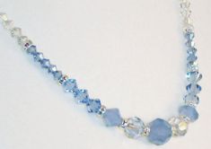 Beautiful necklace in Air Blue Swarovski crystals, Swarovski clear crystals, light blue clear crystals, dainty, feminine, choker, Swarovski silver-plated crystal rondelles.  I can picture this necklace with a white, frilly, peasant-type blouse and a pair of blue jeans. Itsis versatile yet simple style makes a statement and with just a touch of bling.  It starts with Swarovski Crystal air blue opals that are almost a periwinkle color and are semi-opaque yet still pick-up colors in the light and o Blue Crystal Necklace With Faceted Beads, Blue Crystal Necklaces With Faceted Beads, Blue Crystal Necklaces For Wedding, Blue Crystal Necklace For Wedding, Periwinkle Color, Swarovski Crystal Necklace, Necklace Simple, Pretty Necklaces, Crystal Choker