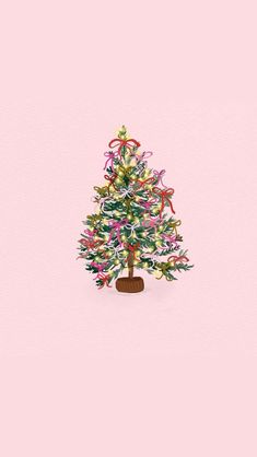 a small christmas tree on a pink background