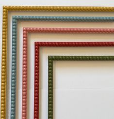 four different colored frames on a white wall