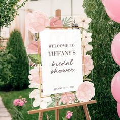 a sign that says, welcome to tiffany's bridal shower with pink flowers