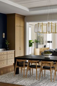 a dining room and living room with wood furniture